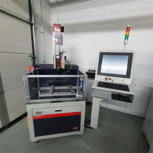Industrial CNC machine with monitor and control panel in a workshop setting.